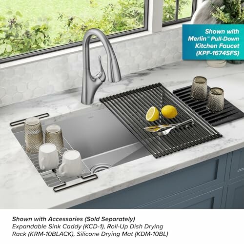 Modern kitchen sink with faucet, drying racks, and cups.