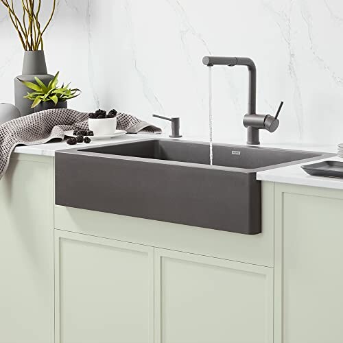 Modern kitchen with a black farmhouse sink and sleek faucet.