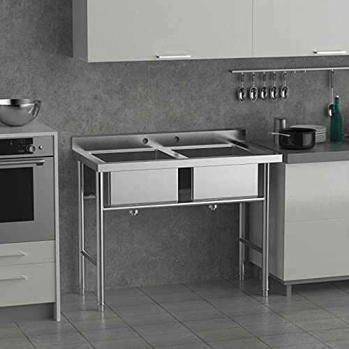 Stainless steel kitchen sink with double basins and a modern design.